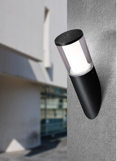 Black outdoor wall light fixture mounted on a concrete wall