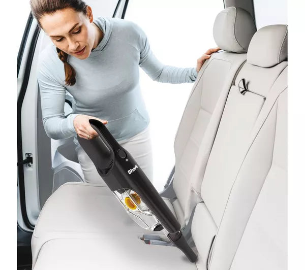 Shark Classic Handheld Pet Vacuum CH950UKT - Woman cleaning car seats with a handheld vacuum cleaner.